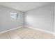 Cozy bedroom with tile floors, light gray walls, and a window with blinds at 5325 Curry Ford Rd # G202, Orlando, FL 32812