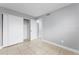 Cozy bedroom featuring tiled floors, fresh paint, and a spacious sliding door closet at 5325 Curry Ford Rd # G202, Orlando, FL 32812