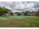 Community outdoor recreation area featuring tennis and shuffleboard courts and brick buildings at 5325 Curry Ford Rd # G202, Orlando, FL 32812