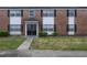 Charming brick apartment building featuring black shutters and well-manicured landscaping at 5325 Curry Ford Rd # G202, Orlando, FL 32812