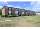 Traditional two-story brick apartment building with dark shutters and trimmed green shrubs at 5325 Curry Ford Rd # G202, Orlando, FL 32812