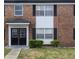 Charming brick apartment building featuring black shutters and well-manicured landscaping at 5325 Curry Ford Rd # G202, Orlando, FL 32812