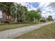 Exterior view of complex showing sidewalk, grass, mature trees and brick apartment buildings at 5325 Curry Ford Rd # G202, Orlando, FL 32812