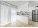 Modern kitchen with white cabinets, stainless steel appliances, and marble countertops at 5325 Curry Ford Rd # G202, Orlando, FL 32812