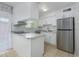 Modern kitchen featuring stainless steel appliances, white cabinets, and marble countertops at 5325 Curry Ford Rd # G202, Orlando, FL 32812