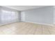 Inviting living room featuring tile floors, light gray walls, and a white entry door at 5325 Curry Ford Rd # G202, Orlando, FL 32812