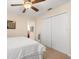A calm bedroom featuring a comfortable bed, ceiling fan, and spacious closet at 7349 Ella Ln, Windermere, FL 34786