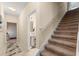 Inviting foyer with tiled floor, stairs, and access to a half-bath with pedestal sink at 7349 Ella Ln, Windermere, FL 34786