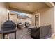 Cozy covered patio with brick pavers, outdoor seating, and a grill, perfect for relaxing or entertaining at 7349 Ella Ln, Windermere, FL 34786