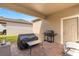 Cozy covered patio featuring brick pavers, outdoor grill, and seating area at 7349 Ella Ln, Windermere, FL 34786