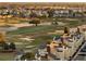 Aerial view of houses and a golf course with many sand traps at 7518 Seven Eagles Way # 201, Reunion, FL 34747