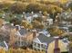 Beautiful aerial view showcasing yellow condos, lush greenery, and palm trees, near a golf course at 7518 Seven Eagles Way # 201, Reunion, FL 34747