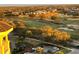 Stunning aerial view overlooking a golf course, lake and neighborhood with a peek of a bright sunrise at 7518 Seven Eagles Way # 201, Reunion, FL 34747