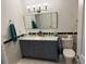 Bathroom features a double sink vanity with marble countertop and a modern toilet at 7518 Seven Eagles Way # 201, Reunion, FL 34747