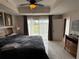 Comfortable bedroom featuring a ceiling fan, artwork, and sliding glass door leading to outdoor space at 7518 Seven Eagles Way # 201, Reunion, FL 34747