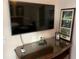 Bedroom corner featuring a modern TV, framed pictures, and a dark wood dresser at 7518 Seven Eagles Way # 201, Reunion, FL 34747