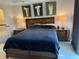 Cozy bedroom featuring a plush bed, decorative artwork, and bedside tables with lamps at 7518 Seven Eagles Way # 201, Reunion, FL 34747