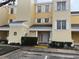 Charming two-story condo building featuring a yellow exterior and white trim at 7518 Seven Eagles Way # 201, Reunion, FL 34747