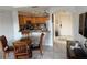 Open kitchen featuring wooden cabinetry, stainless steel appliances, and a view of the dining area at 7518 Seven Eagles Way # 201, Reunion, FL 34747