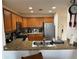 Spacious kitchen with granite countertops, stainless steel appliances, and wood cabinetry at 7518 Seven Eagles Way # 201, Reunion, FL 34747