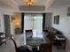 Inviting living room featuring a glass table, golf course views, and neutral tones at 7518 Seven Eagles Way # 201, Reunion, FL 34747