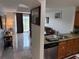 Inviting living space with kitchen features granite countertops and a stainless steel dishwasher at 7518 Seven Eagles Way # 201, Reunion, FL 34747