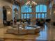 An elegant lobby with a large chandelier, water feature, high ceilings, and many tables with chairs at 7518 Seven Eagles Way # 201, Reunion, FL 34747