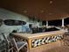 A poolside bar with a colorful tile design, offering a variety of drinks and a relaxing atmosphere at 7518 Seven Eagles Way # 201, Reunion, FL 34747