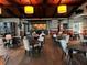 A relaxed interior with tables and seating in restaurant with a bar at 7518 Seven Eagles Way # 201, Reunion, FL 34747
