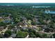 Expansive aerial view showcasing a neighborhood with mature trees, lakes, and well-maintained homes at 7703 Pine Vista Ct, Orlando, FL 32819