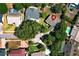 An aerial view showcases the neighborhood layout with houses, mature landscaping, and red pin at 7703 Pine Vista Ct, Orlando, FL 32819