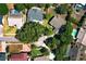 An aerial view showcases the layout of the neighborhood with mature landscaping and nearby houses and pools at 7703 Pine Vista Ct, Orlando, FL 32819