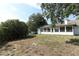 Exterior backyard view, showcasing a well-maintained lawn and partial fencing at 7703 Pine Vista Ct, Orlando, FL 32819