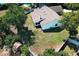 An aerial view of a backyard with a large lawn and mature trees, offering privacy and shade at 7703 Pine Vista Ct, Orlando, FL 32819