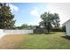 Well-maintained backyard with partial privacy fence, complemented by mature trees for added serenity at 7703 Pine Vista Ct, Orlando, FL 32819