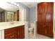 Well-lit bathroom showcasing a vanity, toilet, and glass-enclosed shower at 7703 Pine Vista Ct, Orlando, FL 32819
