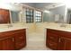 Bright bathroom with double sinks, a soaking tub, and ample storage space at 7703 Pine Vista Ct, Orlando, FL 32819