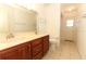 Bright bathroom featuring double sinks, a large mirror, and a separate toilet and shower area at 7703 Pine Vista Ct, Orlando, FL 32819