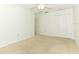 Open bedroom featuring neutral carpet, ceiling fan, and double door closets at 7703 Pine Vista Ct, Orlando, FL 32819