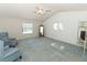 Spacious bedroom featuring a ceiling fan, floral wallpaper, and ample natural light from the windows at 7703 Pine Vista Ct, Orlando, FL 32819