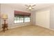 Comfortable bedroom with a large window, closet, and neutral tones at 7703 Pine Vista Ct, Orlando, FL 32819