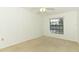 Bright bedroom with neutral carpet and a large window offering natural light and scenic views at 7703 Pine Vista Ct, Orlando, FL 32819