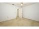 Clean bedroom features a ceiling fan and a door at 7703 Pine Vista Ct, Orlando, FL 32819