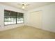 Bedroom has a ceiling fan, carpet, closet, and natural light at 7703 Pine Vista Ct, Orlando, FL 32819