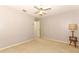 Spacious bedroom with neutral carpet, ceiling fan, and a view of the hallway for easy access at 7703 Pine Vista Ct, Orlando, FL 32819