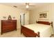 Charming bedroom with a wooden bed frame, dresser, and a view to the hallway at 7703 Pine Vista Ct, Orlando, FL 32819