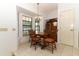 A dining area is lit by a chandelier and features a window with black grids at 7703 Pine Vista Ct, Orlando, FL 32819