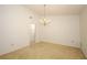 Open dining area featuring chandelier lighting and neutral carpet at 7703 Pine Vista Ct, Orlando, FL 32819