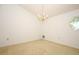 Simple dining area featuring a chandelier, neutral carpet, and natural light at 7703 Pine Vista Ct, Orlando, FL 32819