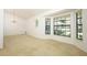 Dining room with bay windows, chandelier lighting, and neutral carpet at 7703 Pine Vista Ct, Orlando, FL 32819